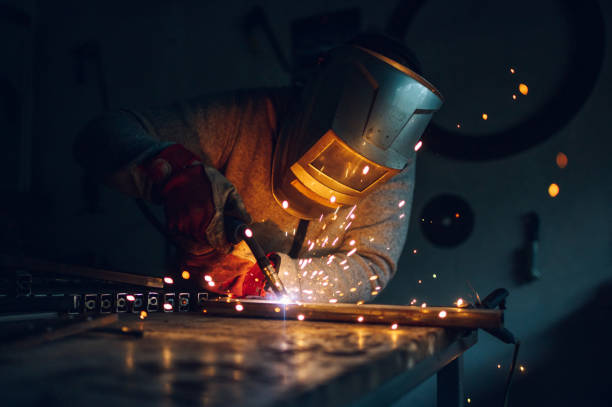 Man welding metal in a workshop